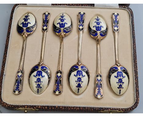 A cased set of HM silver teaspoons with blue cream and gilt enamel decoration