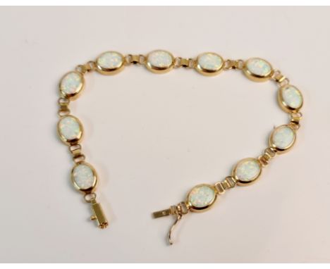 A stamped 585 opal link bracelet of 11 opals, approx. length 18cms