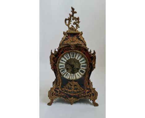A French Empire boulle work style mantle clock will shell and leaf design brass height 57 cm.