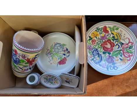A collection of Poole pottery vases and plates.