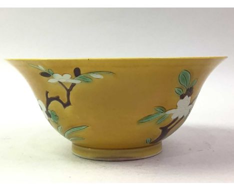 CHINESE YELLOW GLAZED BOWL, KANGXI STYLE decorated with flowering branches, the base bearing square mark within a blue double