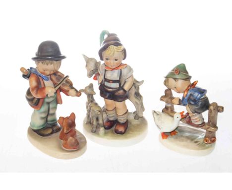 Three Hummel children figures