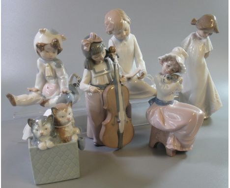 Five Nao Spanish porcelain figurines of young children together with a Nao porcelain figure group of two cats in a basket.  (