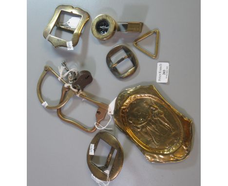 Quantity of military orientated metalware, to include: French repousse pin dish, two bar locks, three buckles, a brass compas