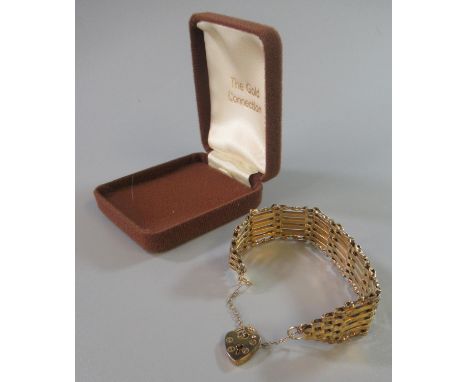 Silver gilt gate bracelet with heart shaped padlock.   (B.P. 21% + VAT) 