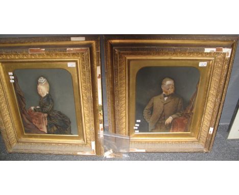 Victorian school, a pair of overpainted photographs of a bewhiskered gentleman and a lady, in glazed heavy gilt frames and ar