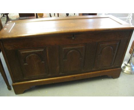 18th century oak coffer, the hinged lid revealing fitted candle box above three arch moulded and fielded panels on projecting