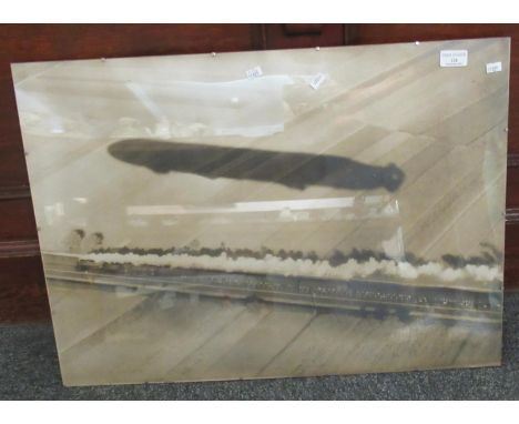 Enlarged First World War photograph apparently depicting the shadow of a Zeppelin (LZ10), over a steam train. 51 x 69cm appro