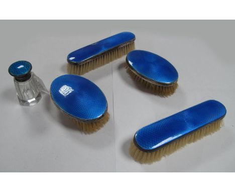 A Set of Four Hallmarked Silver Backed and Blue Enamel Brushes, (damages) together with hallmarked silver and enamel topped b