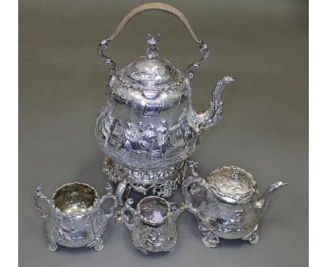 A Victorian matched four piece silver tea set, decorated all over with in repousse depicting joyful scenes including figures 