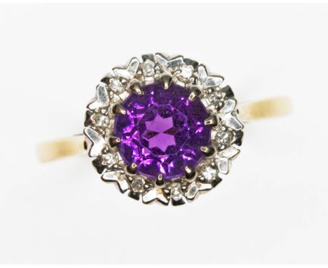 An amethyst and diamond cluster ring, the round cluster measuring approx. 10.50mm in diameter, hallmarked 18ct gold, sponsor 