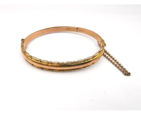 An Edwardian 9ct rose gold bangle by A J Pepper &amp; Co, fancy beaded detailing to the D-shaped bangle, fastens with invisib