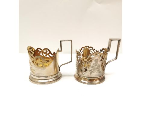 Two silver gilded and engraved floral design Russian openwork tea glass holders, one decorated with stylised bluebells and fl