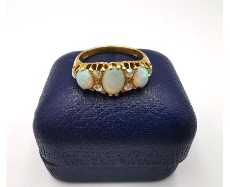 A boxed Victorian 18ct yellow gold opal and rose cut diamond carved half hoop ring by Alabaster &amp; Wilson, set with three 