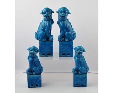 A SUITE OF FOUR ORIENTAL CERAMIC DOGS OF FO each in seated pose with square integral plinths and all over blue glaze, pair 32