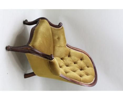 A VICTORIAN SHOW WOOD FRAMED BUTTON BACK SALON CHAIR, having scroll arms, gold dralon upholstery, on scroll fore feet 