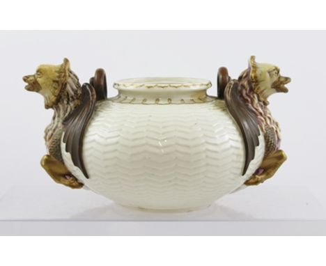 A 19TH CENTURY BELLEEK PORCELAIN FIRST PERIOD POT of squat form with wavy tooling and twin winged mythical beast handles, gil