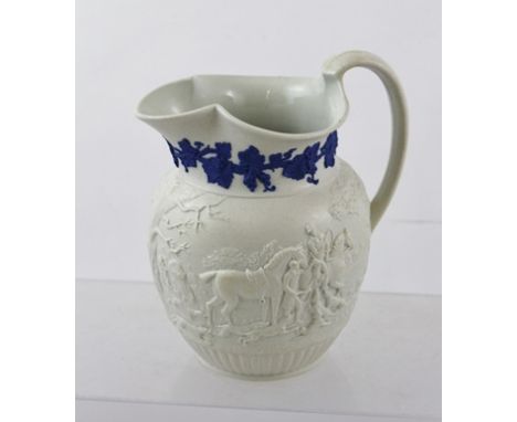 A 19TH CENTURY WEDGWOOD SALT GLAZED MOULDED JUG depicting a hunting scene with blue fruiting vine applied to neck, 17cm high 