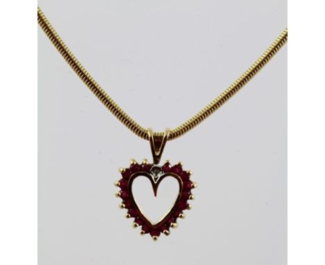 A 9CT GOLD RUBY SET HEART FORM PENDANT, on a 9ct gold chain 