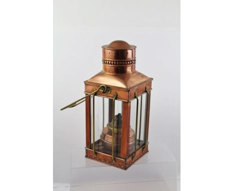 A COPPER SHIP'S LANTERN with brass swing handle, 38cm high 
