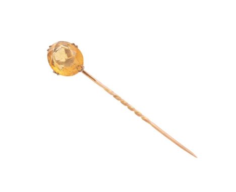 A 9ct gold and citrine stock or stick pin, the oval cut citrine of approximately 10.4 by 13.8mm, apparently unmarked but test