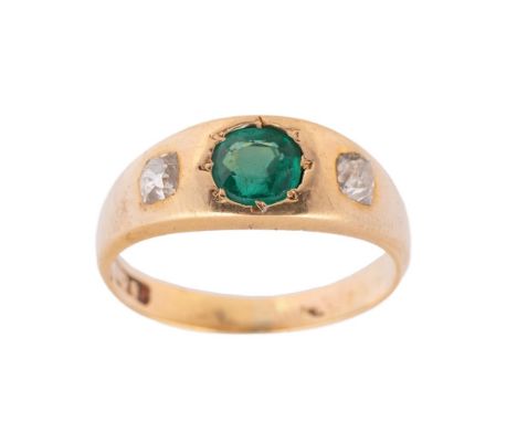 An 18ct gold, diamond and emerald set ring, the central inset emerald of approximately 6.1mm diameter, with cushion cut diamo