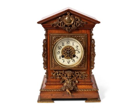 19th century French oak mantel clock, eight day movement striking the hours and half hours, white ceramic dial with Gothic st