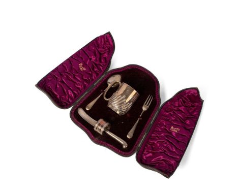 A Victorian silver christening set, comprising mug with swirling gadrooned belly, and gilt interior, napkin ring, fork, spoon