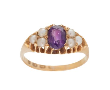 An Edwardian 18ct gold and seed pearl dress ring, set with oval cut amethyst of approximately 5 by 8mm, adjoined by three see
