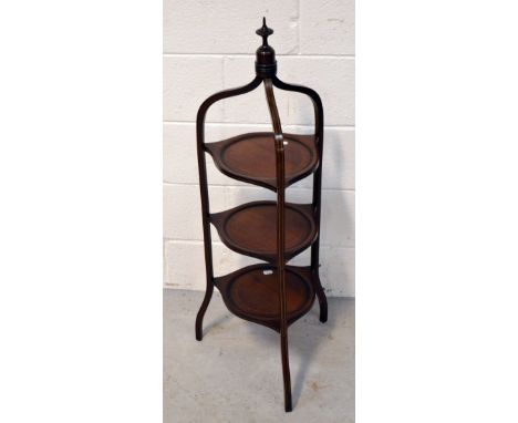An Edwardian mahogany inlaid cake stand on curved supports with shaped finial to the top, height 97cm.