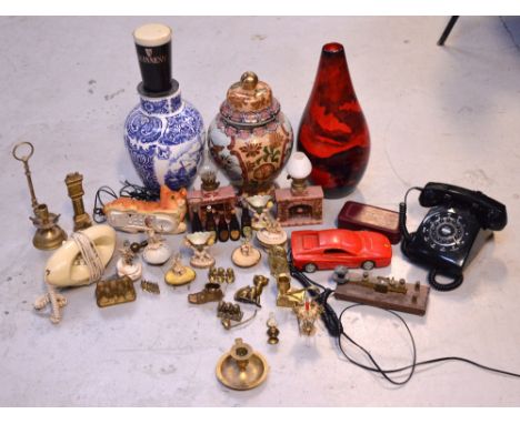A collectors' lot comprising three decorative ceramic vases, Guinness-related collectibles, a quantity of brassware, vintage 