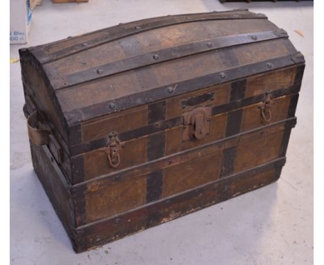 A Victorian oak bound and studded dome top travel trunk with canvas carry handles and riveted iron straps, approx 85 x 60cm.