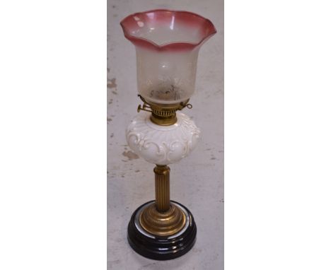 A Victorian oil lamp with brass column base and etched rose coloured glass shade, converted to electricity, height 53cm.