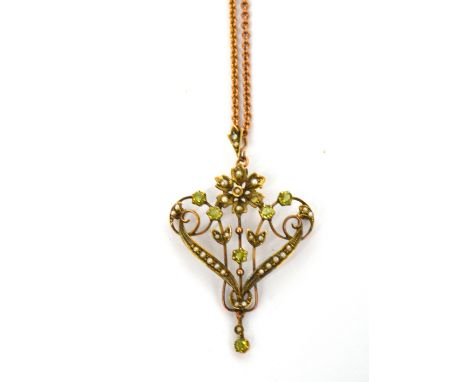 An Edwardian 9ct yellow gold pendant set with green stones and seed pearls on a 9ct rose gold chain, approx 8.4g.