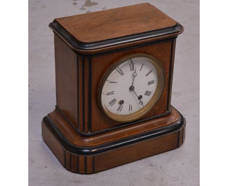 A walnut cased eight day mantel clock, the enamel dial set with Roman numerals, height 27cm.