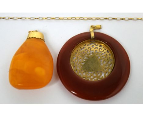 A 9ct gold mounted amber pendant with 9ct yellow gold chain and a similar amber-coloured yellow metal mounted pendant (2).