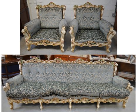 A large ornate cream ground, floral encrusted framed, blue velvet upholstered button back sofa, approx width 245cm, and a pai