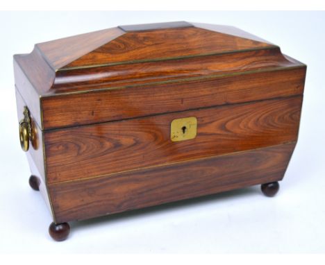 A Regency rosewood sarcophagus tea caddy, the hinged lid revealing two lidded compartments and central associated glass bowl,