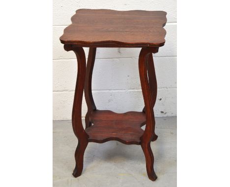 An oak side table with curved rim, lower shelf on curved supports, 71 x 46cm.