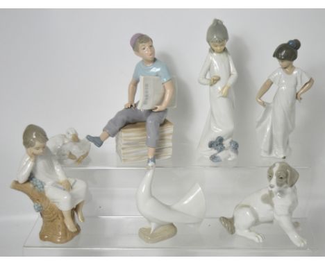 A Lladró figure of a young boy sitting on a tree trunk and six further Nao figures to include three examples modelled as anim