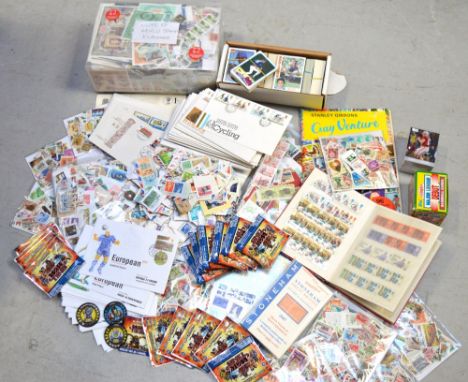 A large collection of world wide stamps, mostly loose, first day covers and a large selection of American trade cards.