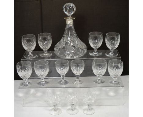 A ship's decanter with hallmarked silver collar and a small quantity of matched glasses.