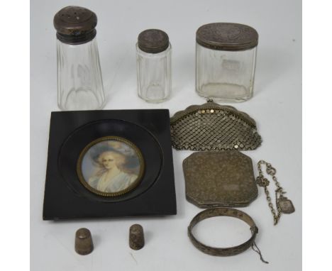 Two cut glass dressing table jars with hallmarked silver covers, a cut glass sugar sifter with a hallmarked silver top, a hal