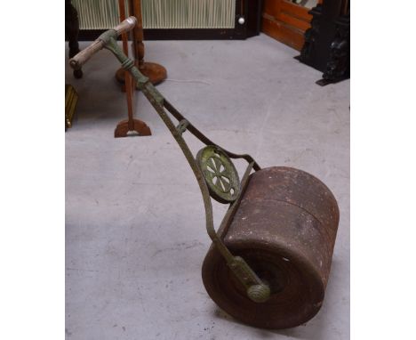A vintage green painted iron garden roller.