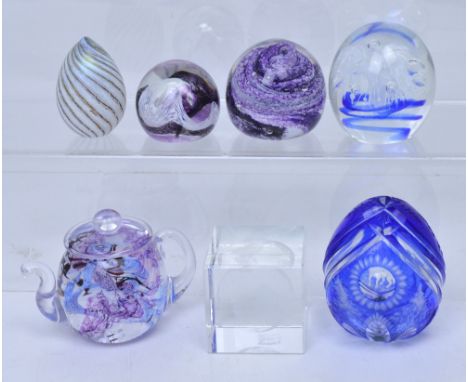 A collection of seven glass paperweights to include a Caithness, Urdale, and Isle of Wight examples, a paper weight in the fo