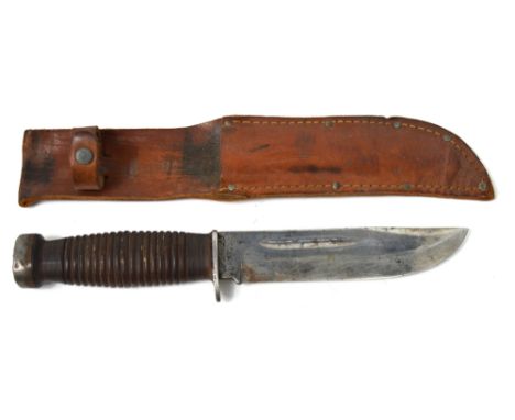 A mid 20th century Case XX knife in leather scabbard.