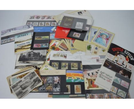A small collection of stamps, presentation packs, commemorative first day covers, postcards and other ephemera.