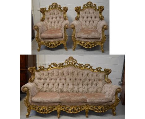 A large ornate gilt wooden framed pink velvet upholstered button back sofa, approx width 200cm, and a pair of matching armcha