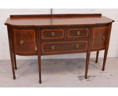 An Edwardian mahogany and inlaid sideboard, two short drawers above long lower drawer, each with brass ring handles flanked e