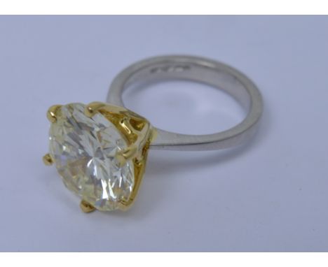 An incredible platinum diamond solitaire ring, the round brilliant cut stone weighing approx 9.50ct in yellow gold six claw p